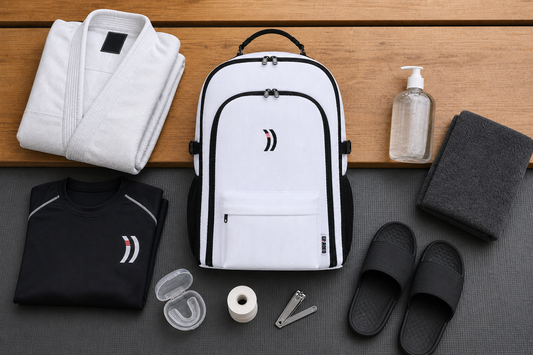 BJJ hygiene essentials arranged around the Graded Backpack